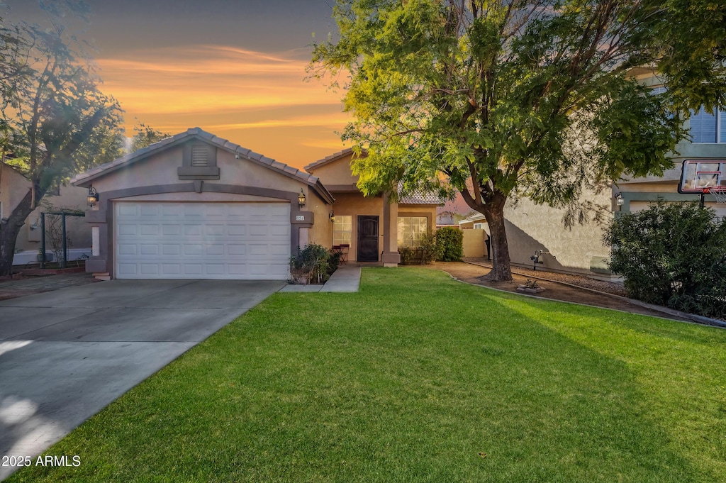 view of front of property featuring a yard and a garage