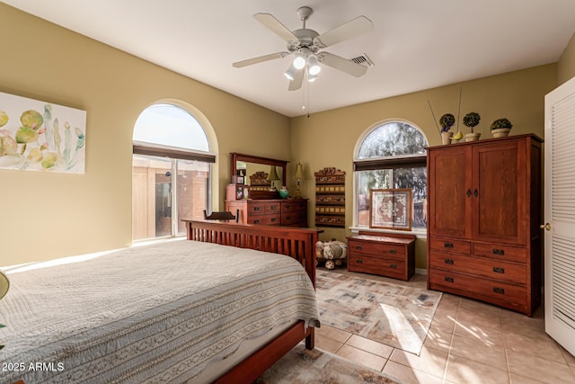 bedroom featuring light tile patterned floors and ceiling fan