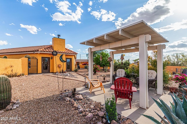 view of patio featuring a gate, fence, and a pergola