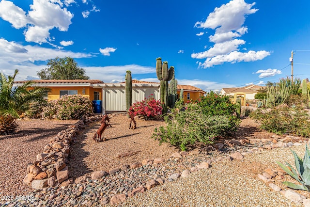 rear view of property with stucco siding and a tile roof