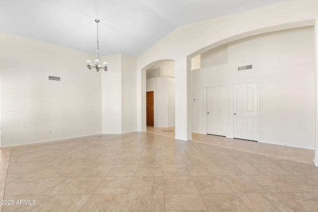 empty room featuring an inviting chandelier, arched walkways, visible vents, and high vaulted ceiling