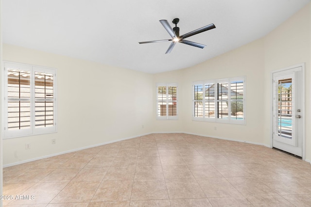 spare room featuring light tile patterned flooring, baseboards, a ceiling fan, and lofted ceiling