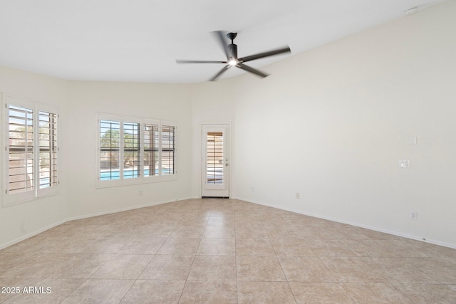 unfurnished room with light tile patterned flooring, baseboards, and ceiling fan