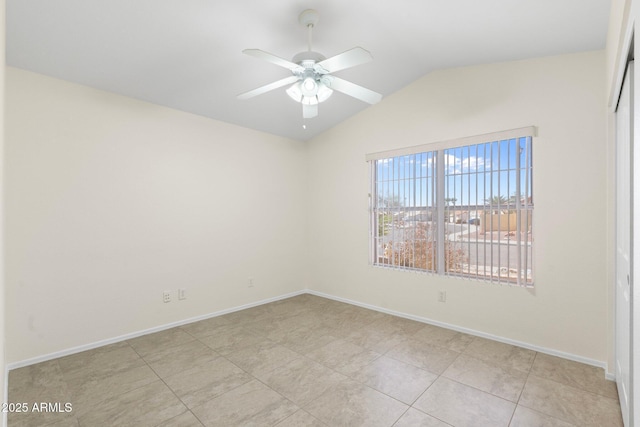 spare room featuring light tile patterned floors, baseboards, lofted ceiling, and ceiling fan