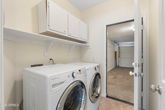 laundry room featuring cabinet space, independent washer and dryer, and light tile patterned flooring