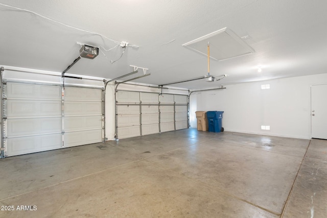 garage featuring a garage door opener and baseboards