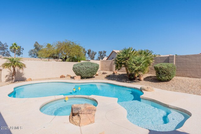 view of swimming pool featuring a fenced in pool, an in ground hot tub, and a fenced backyard