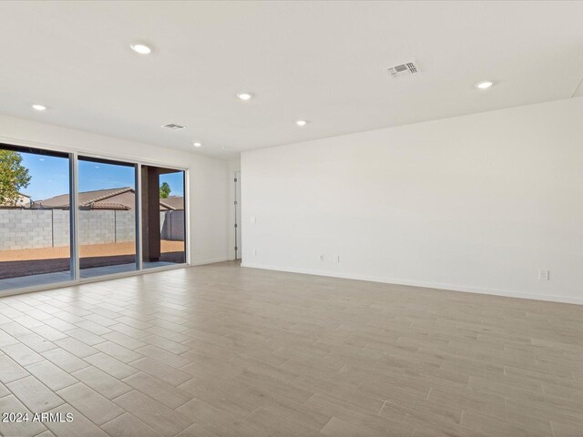 spare room featuring light hardwood / wood-style floors