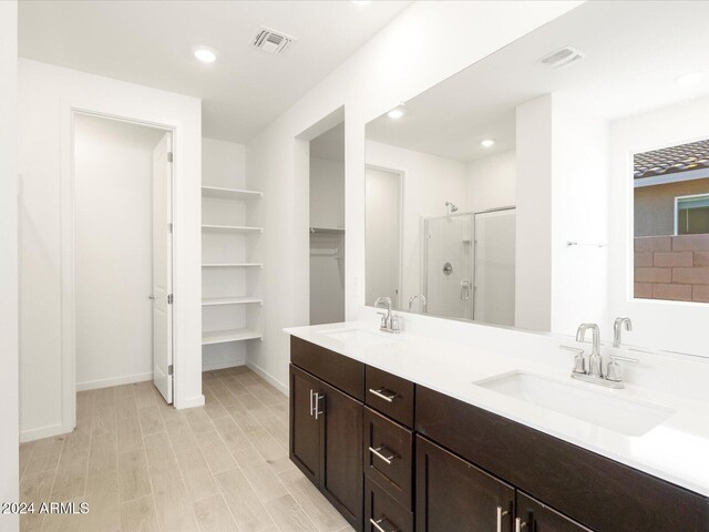 bathroom featuring vanity and an enclosed shower