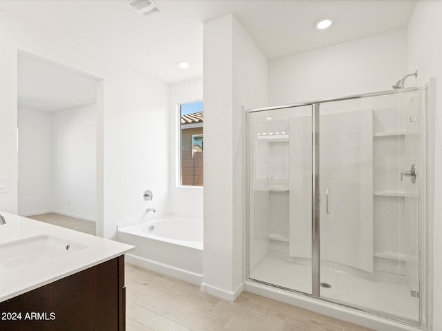 bathroom featuring vanity and separate shower and tub