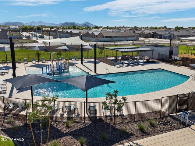 view of swimming pool with a mountain view