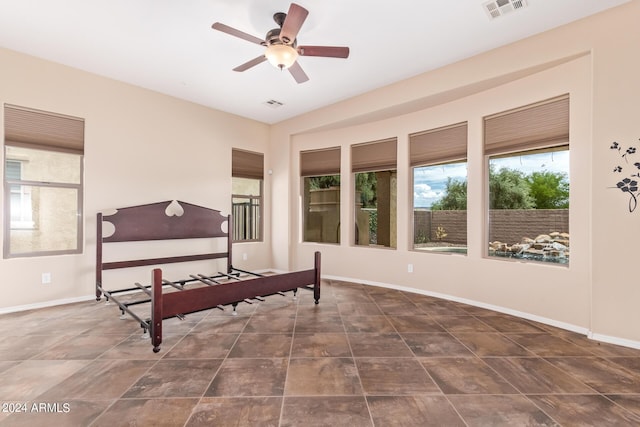 bedroom with ceiling fan and tile patterned floors