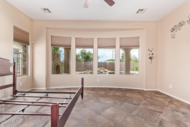 interior space with tile patterned flooring, plenty of natural light, and ceiling fan