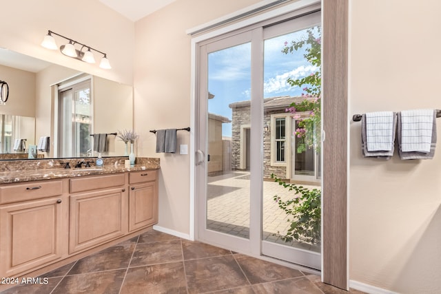 bathroom with tile patterned flooring and vanity