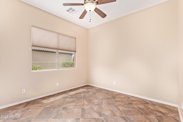 empty room featuring ceiling fan and tile patterned floors