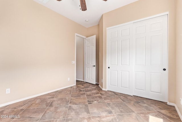 unfurnished bedroom with ceiling fan, tile patterned flooring, and a closet