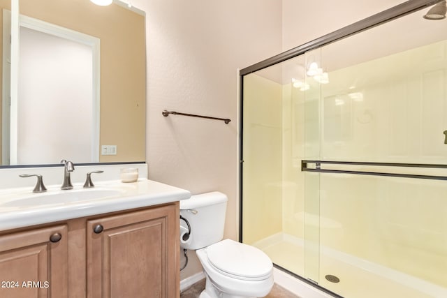 bathroom with vanity, walk in shower, and toilet