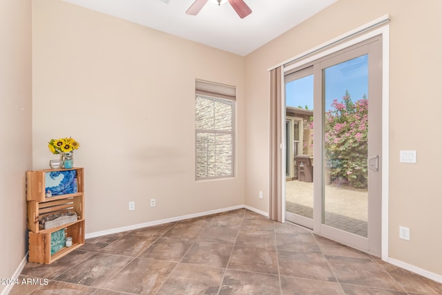 tiled empty room with ceiling fan