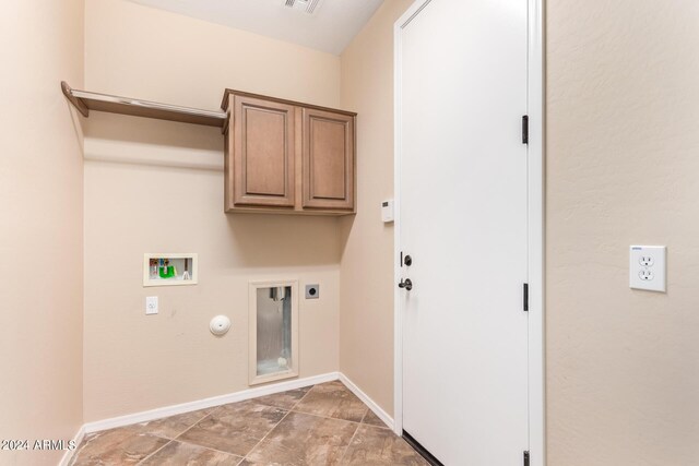 laundry area with electric dryer hookup, gas dryer hookup, washer hookup, cabinets, and tile patterned flooring