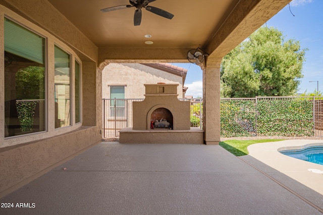 view of patio / terrace with ceiling fan and exterior fireplace