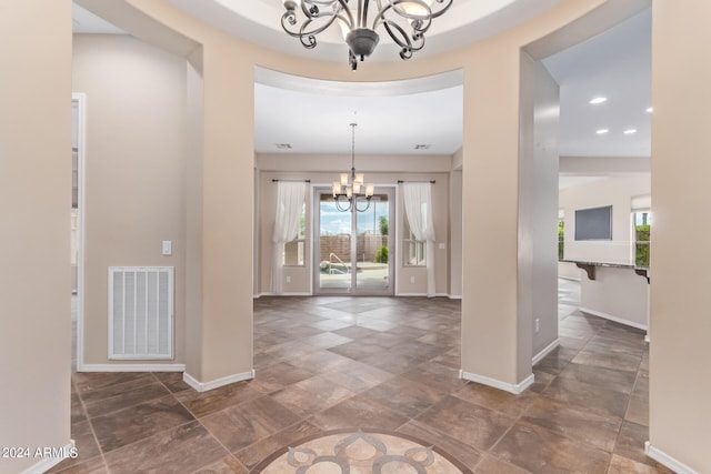 interior space featuring a healthy amount of sunlight and an inviting chandelier