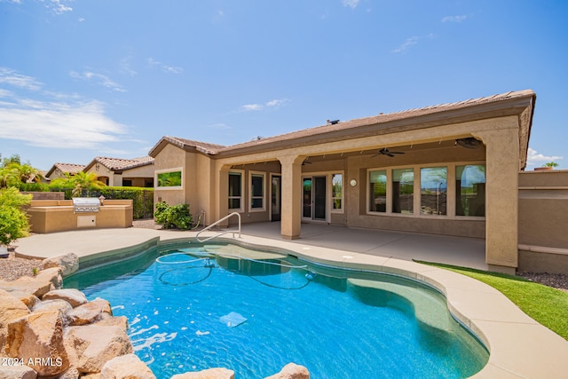 view of swimming pool featuring ceiling fan, exterior kitchen, and a patio