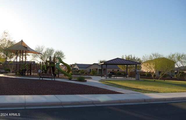 view of front of house featuring a playground, a gazebo, and a front yard