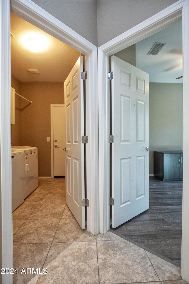 hallway with independent washer and dryer