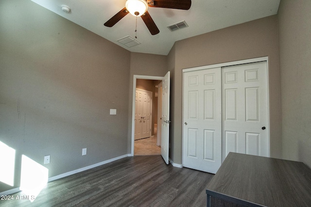 unfurnished bedroom with a closet, dark hardwood / wood-style floors, and ceiling fan