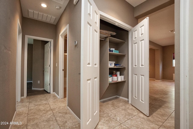 corridor with light tile patterned floors