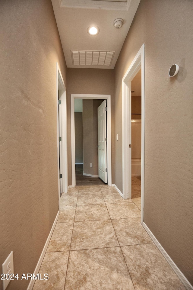 corridor featuring light tile patterned floors