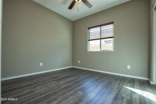 spare room featuring lofted ceiling, dark wood-type flooring, and ceiling fan