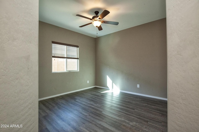 unfurnished room featuring dark hardwood / wood-style floors and ceiling fan