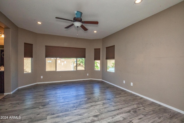 spare room with wood-type flooring and ceiling fan