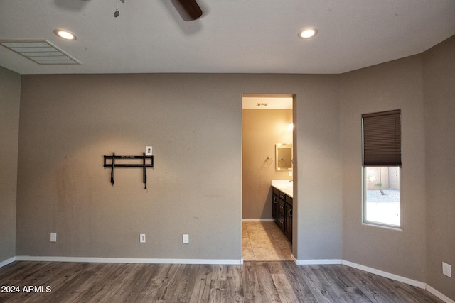 spare room featuring ceiling fan and light hardwood / wood-style flooring