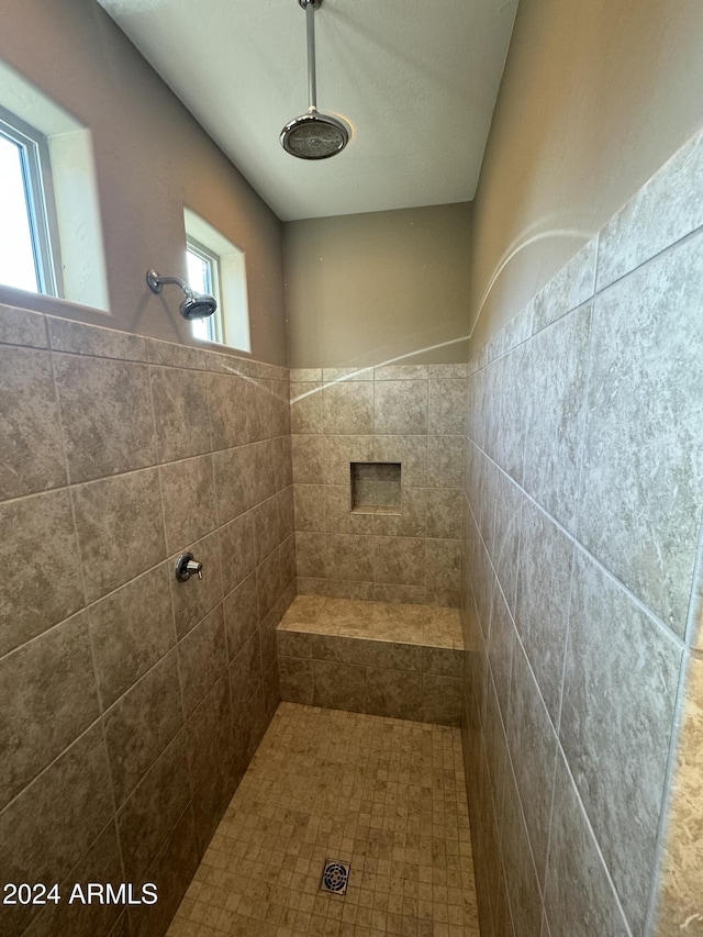 bathroom with a tile shower