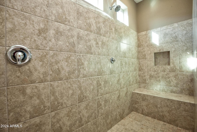 bathroom with tiled shower