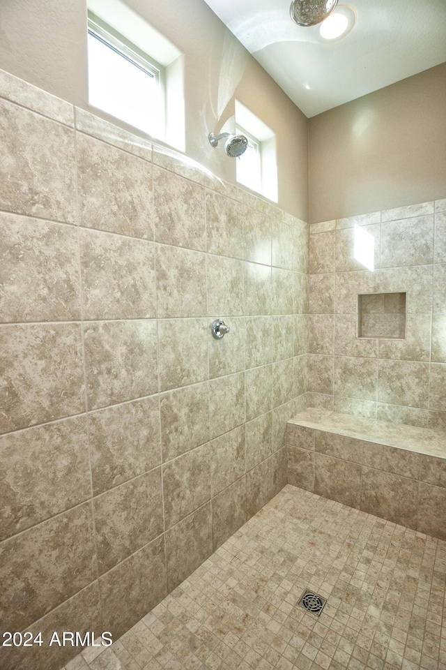 bathroom featuring a tile shower