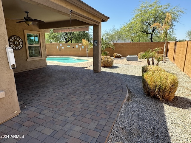 view of patio featuring a fenced in pool and ceiling fan