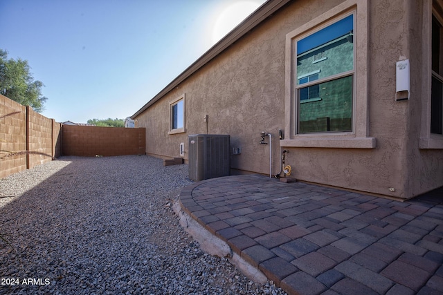 view of side of property featuring cooling unit and a patio area