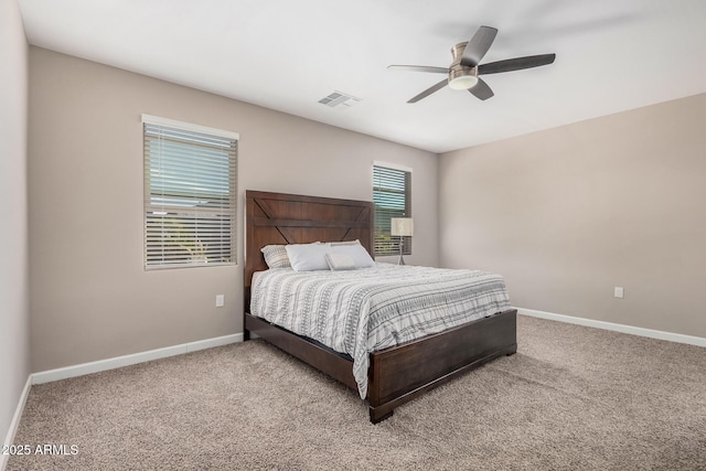 carpeted bedroom with ceiling fan, visible vents, and baseboards