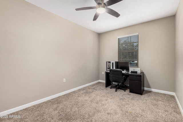 home office featuring baseboards, a ceiling fan, and light colored carpet