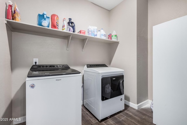 washroom featuring wood tiled floor, laundry area, baseboards, and separate washer and dryer