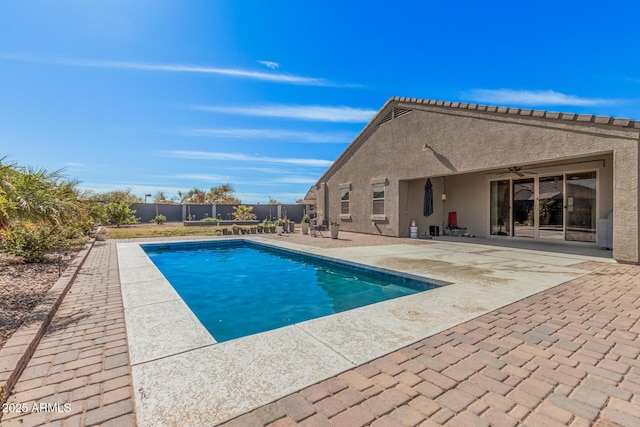 view of swimming pool featuring ceiling fan, a patio, a fenced backyard, and a fenced in pool