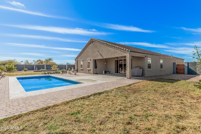 view of pool with a fenced backyard, a ceiling fan, a lawn, a fenced in pool, and a patio area