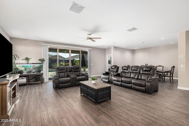 living area featuring wood finished floors, visible vents, and baseboards