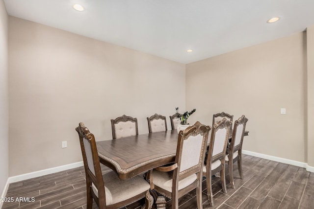 dining space featuring wood finish floors, recessed lighting, and baseboards