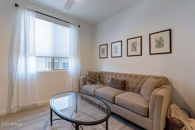 living room with ceiling fan and light hardwood / wood-style floors