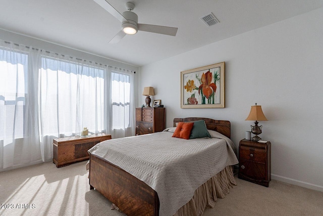 bedroom featuring visible vents, ceiling fan, light carpet, and baseboards