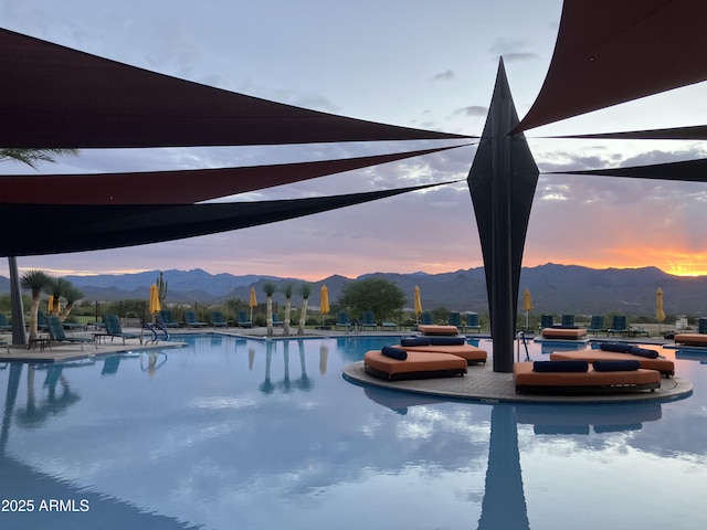 pool with a patio area and a mountain view